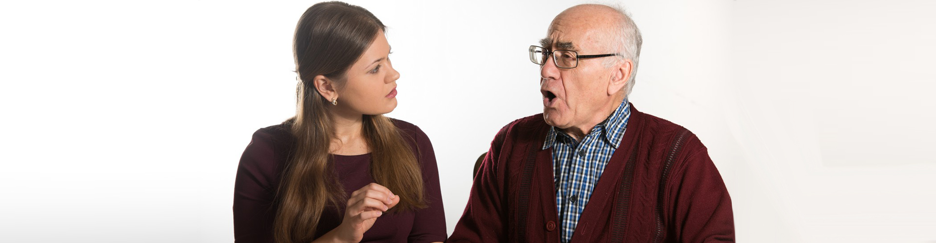 woman teaching a senior man to talk properly